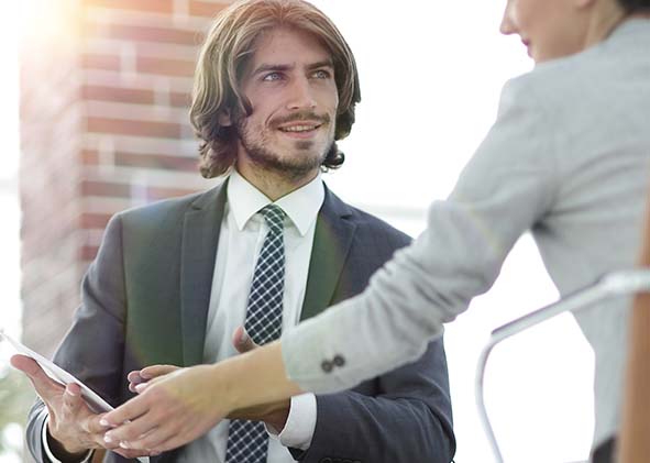 A relaxed conversation of a man and a woman in the office